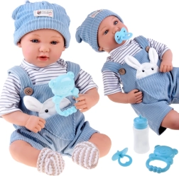 Interaktív baba 46 cm kék kordbársony kertésznadrágban, kiegészítőkkel
