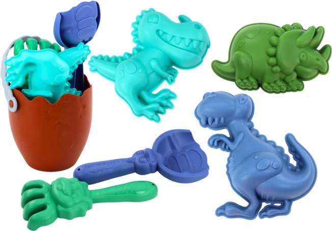 Dínó homokozó készlet tojás alakú vödörrel, lapáttal, gereblyével és formákkal