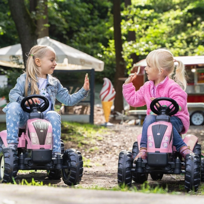 Lánctalpas rózsaszín traktor utánfutóval