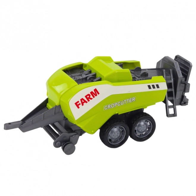 Piros traktor rakodóval és bálázóval