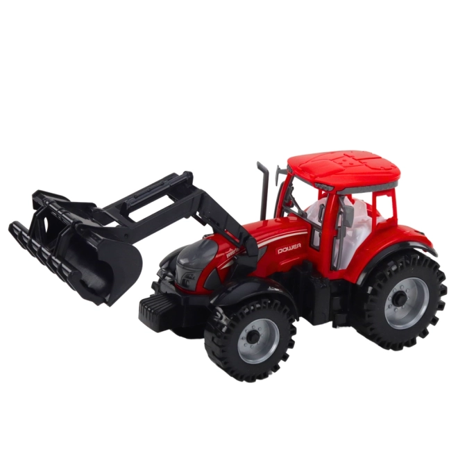 Piros traktor rakodóval és bálázóval
