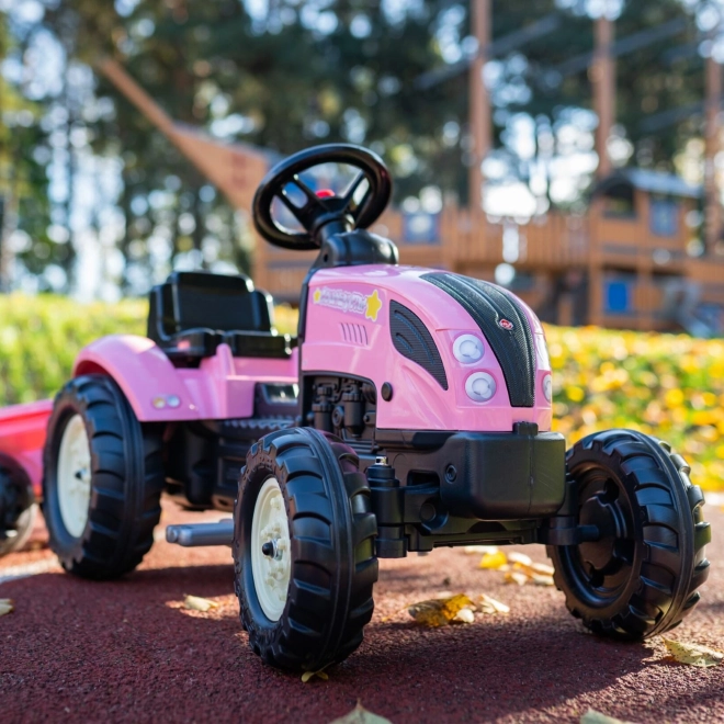 Lánctalpas rózsaszín traktor utánfutóval