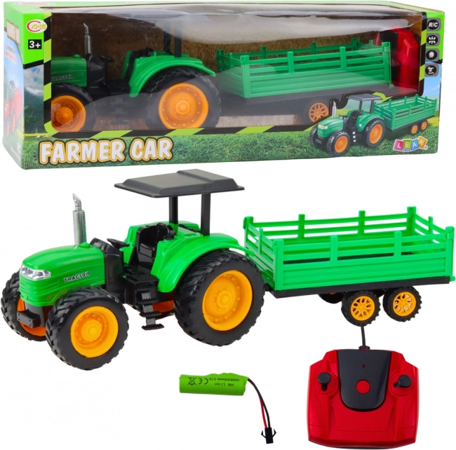 Zöld távirányítású mezőgazdasági traktor utánfutóval