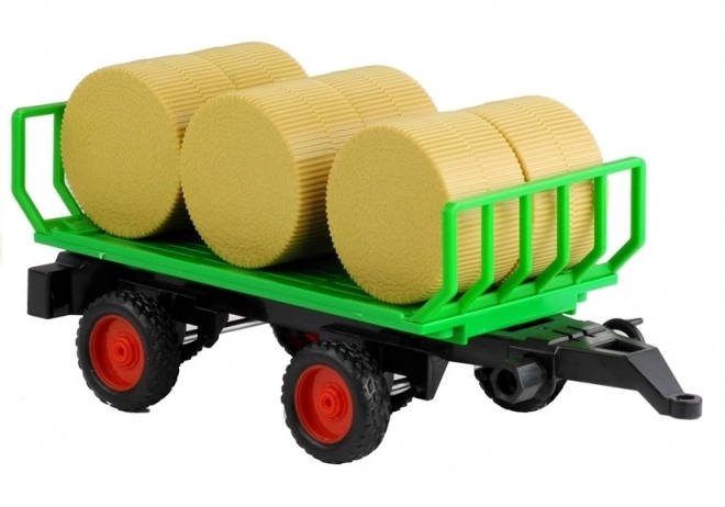 Zöld traktor utánfutóval és szénával