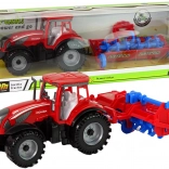 Piros traktor ekével, súrlódásos meghajtással