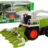 Nagy zöld kombájn mozgó alkatrészekkel