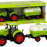 Zöld traktor nagy kerekű utánfutóval